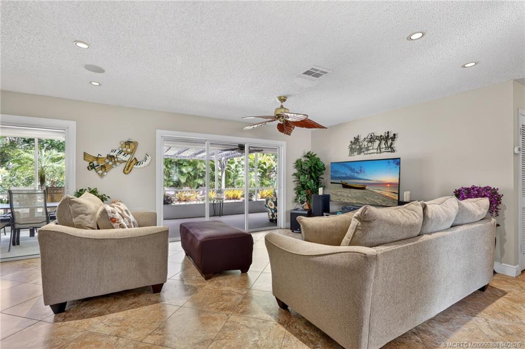 330 Southwest Winnachee Drive Stuart, FL 34994 - Photo 8 of 49 Walk out to the screened patio form this spacious living room.