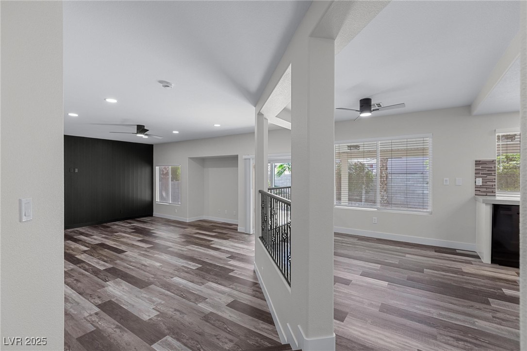 9591 Antelope Bend Court Las Vegas, NV 89148 - Photo 11 of 56 Unfurnished living room with ceiling fan, dark wood-style flooring, and recessed lighting