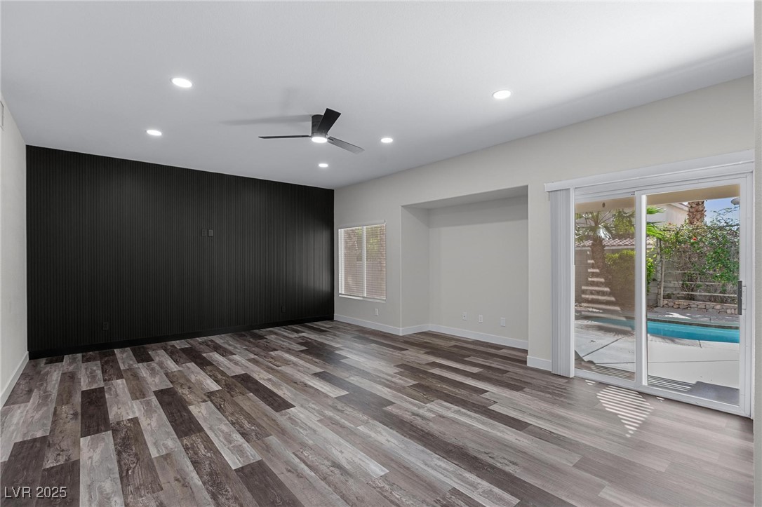 9591 Antelope Bend Court Las Vegas, NV 89148 - Photo 17 of 56 Unfurnished family room with recessed lighting, dark wood-type flooring, and ceiling fan with light