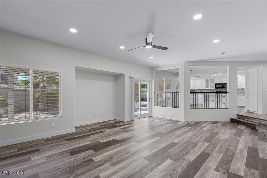 9591 Antelope Bend Court Las Vegas, NV 89148 - Photo 18 of 56 Unfurnished family room with recessed lighting, dark wood-type flooring, and ceiling fan with light