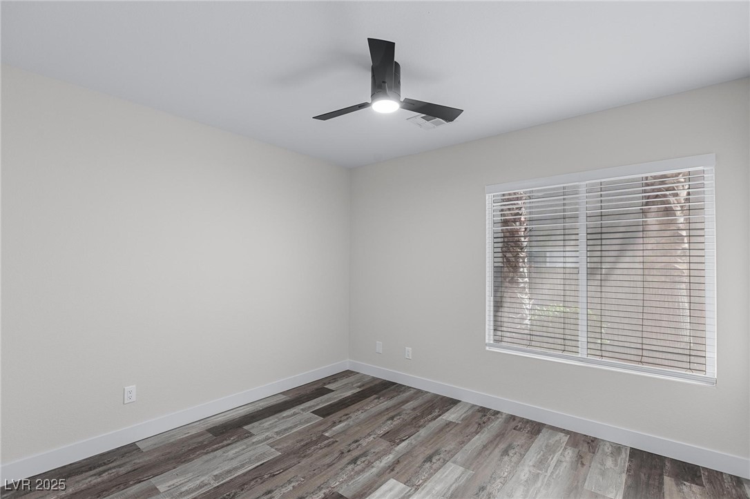 9591 Antelope Bend Court Las Vegas, NV 89148 - Photo 20 of 56 Empty room featuring dark wood-type flooring and ceiling fan with light
