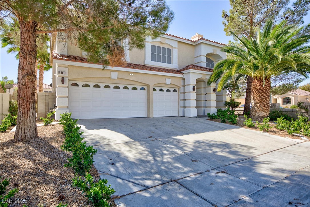 9591 Antelope Bend Court Las Vegas, NV 89148 - Photo 2 of 56 Mediterranean / spanish-style house featuring driveway, a tile roof, stucco siding, and a garage