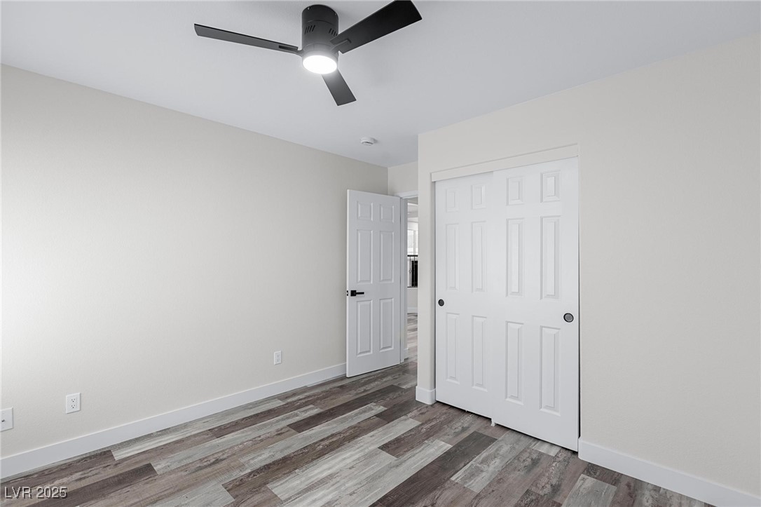 9591 Antelope Bend Court Las Vegas, NV 89148 - Photo 21 of 56 Empty room featuring dark wood-type flooring and ceiling fan with light