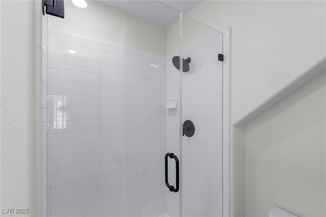 9591 Antelope Bend Court Las Vegas, NV 89148 - Photo 24 of 56 Bathroom view of a shower stall and a textured wall