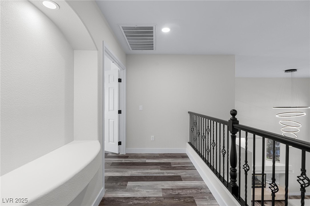9591 Antelope Bend Court Las Vegas, NV 89148 - Photo 26 of 56 Corridor with wood finished floors, recessed lighting, and a chandelier