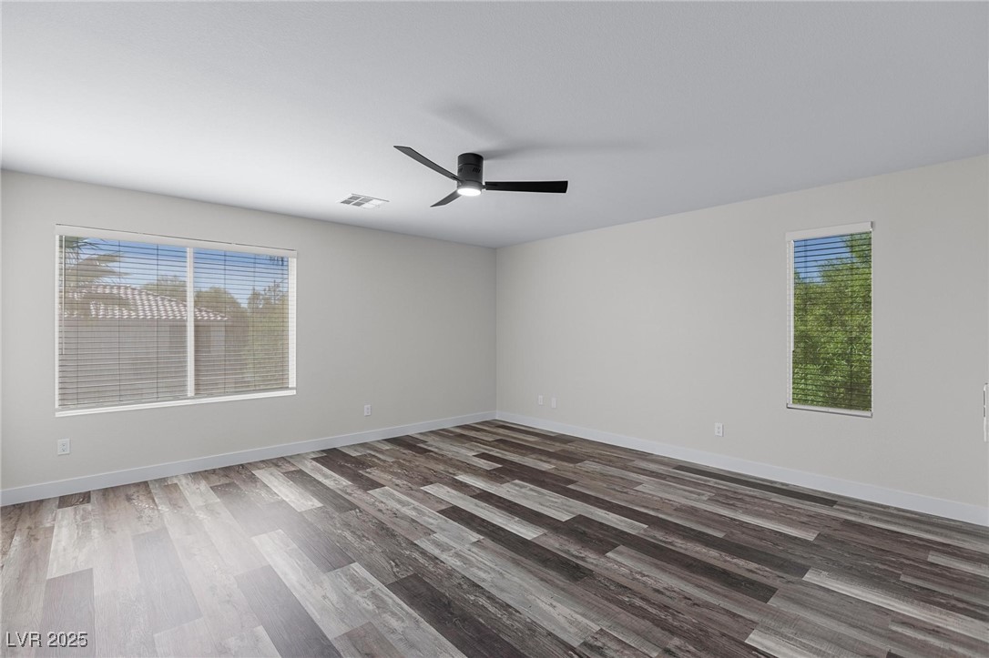 9591 Antelope Bend Court Las Vegas, NV 89148 - Photo 27 of 56 Primary bedroom featuring dark wood-style floors and ceiling fan with light