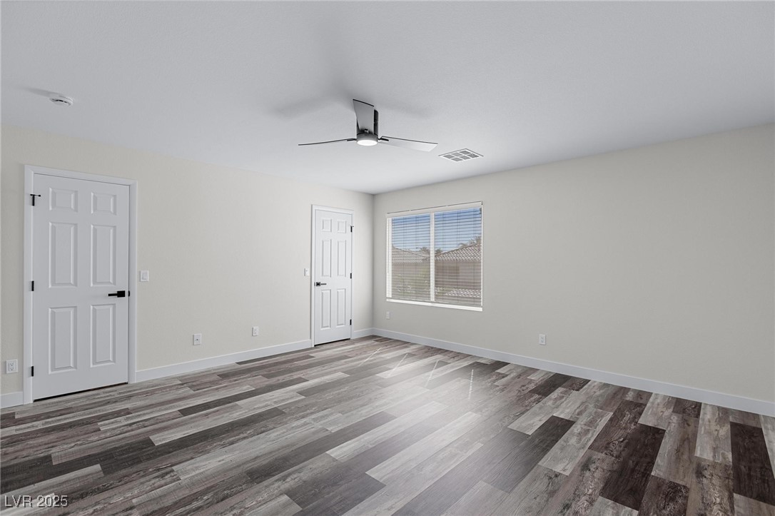 9591 Antelope Bend Court Las Vegas, NV 89148 - Photo 28 of 56 Primary bedroom featuring dark wood-style floors and ceiling fan with light