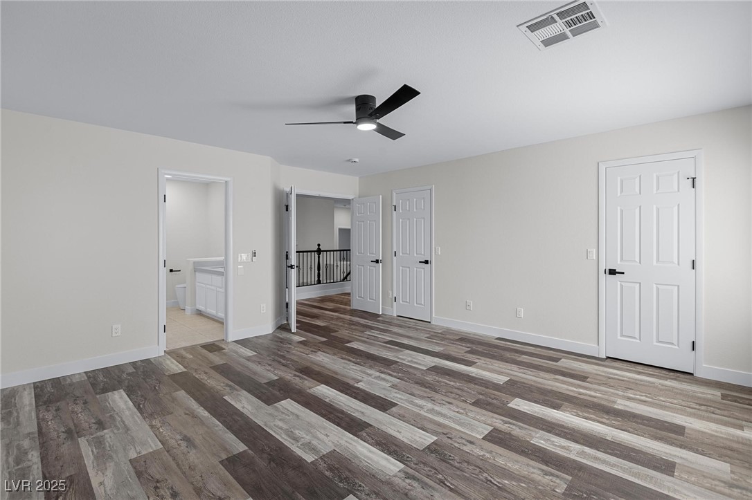 9591 Antelope Bend Court Las Vegas, NV 89148 - Photo 29 of 56 Primary bedroom featuring dark wood-style floors and ceiling fan with light