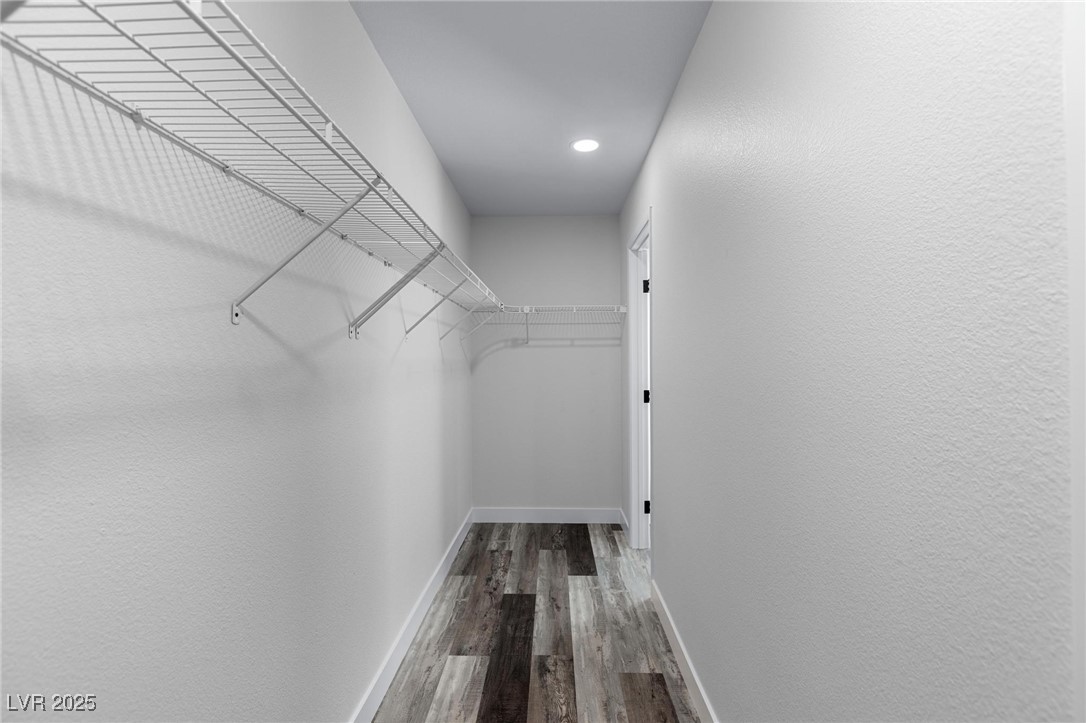 9591 Antelope Bend Court Las Vegas, NV 89148 - Photo 31 of 56 Walk in closet with dark wood-style flooring