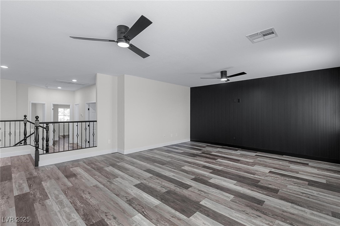 9591 Antelope Bend Court Las Vegas, NV 89148 - Photo 36 of 56 Unfurnished loft featuring dark wood-style floors, ceiling fan, and recessed lighting