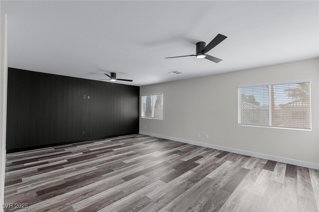 9591 Antelope Bend Court Las Vegas, NV 89148 - Photo 38 of 56 Unfurnished loft featuring dark wood-style floors, a ceiling fan, and recessed lighting