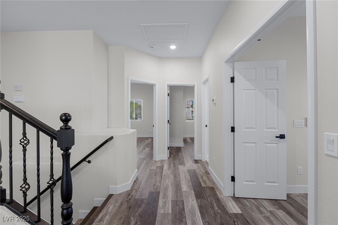 9591 Antelope Bend Court Las Vegas, NV 89148 - Photo 39 of 56 Hallway with dark wood finished floors, recessed lighting, and attic access