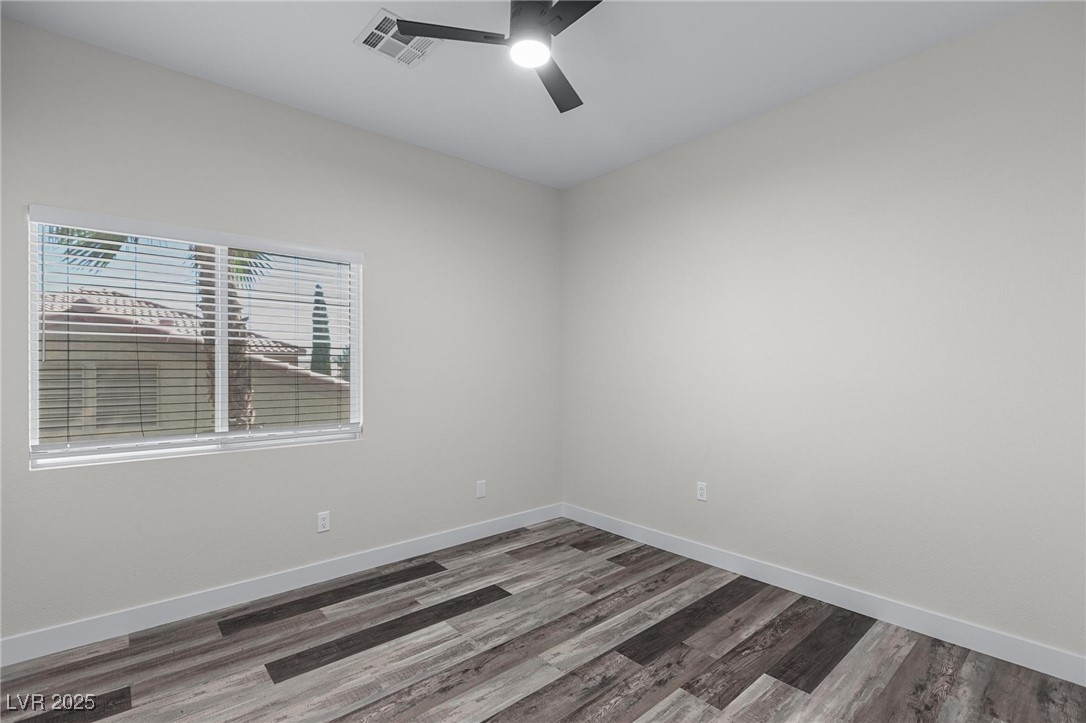 9591 Antelope Bend Court Las Vegas, NV 89148 - Photo 40 of 56 Empty bedroom with dark wood-type flooring and a ceiling fan with light