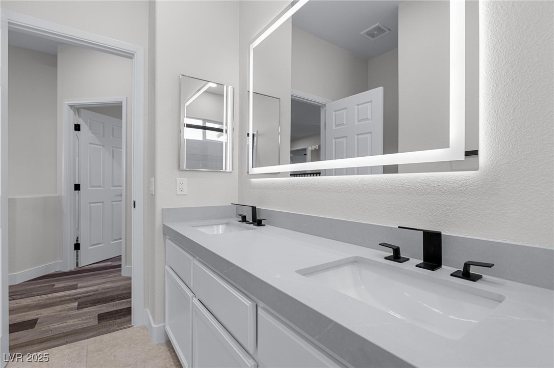9591 Antelope Bend Court Las Vegas, NV 89148 - Photo 43 of 56 Bathroom with double vanity and light wood finished floors