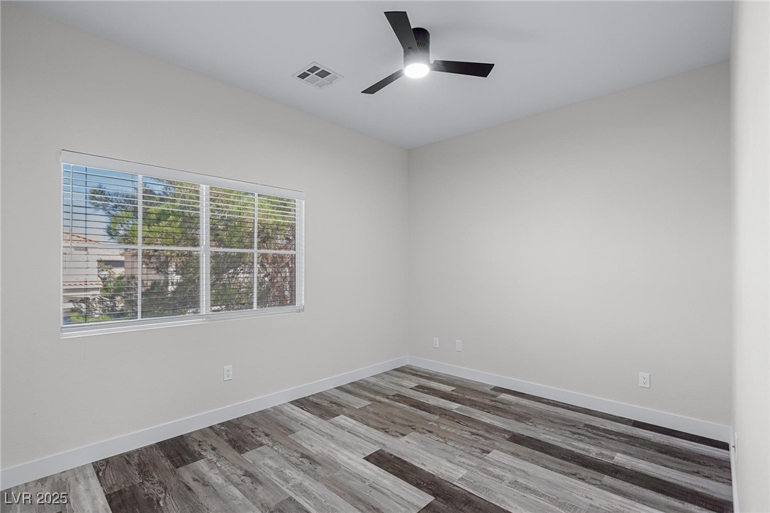 9591 Antelope Bend Court Las Vegas, NV 89148 - Photo 44 of 56 Unfurnished bedroom featuring a closet, dark wood finished floors, and ceiling fan with light