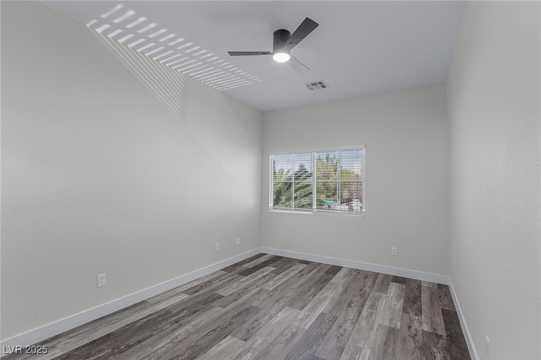 9591 Antelope Bend Court Las Vegas, NV 89148 - Photo 46 of 56 Unfurnished bedroom featuring a closet, dark wood finished floors, and ceiling fan with light