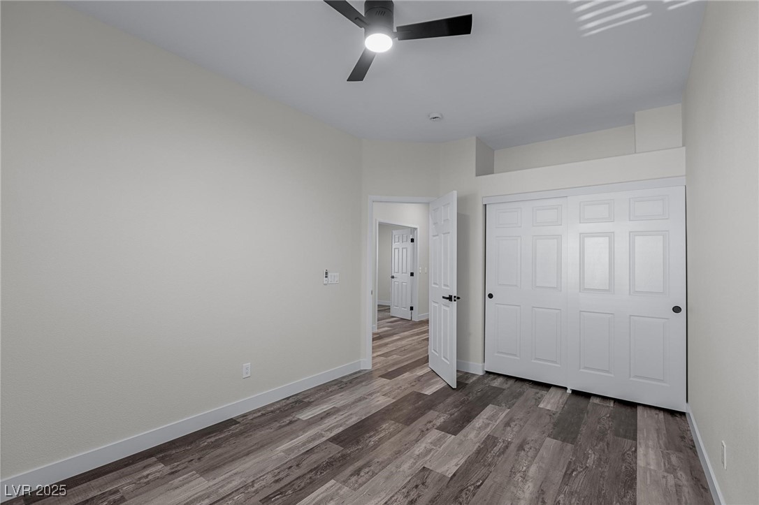 9591 Antelope Bend Court Las Vegas, NV 89148 - Photo 47 of 56 Unfurnished bedroom featuring a closet, dark wood finished floors, and ceiling fan with light