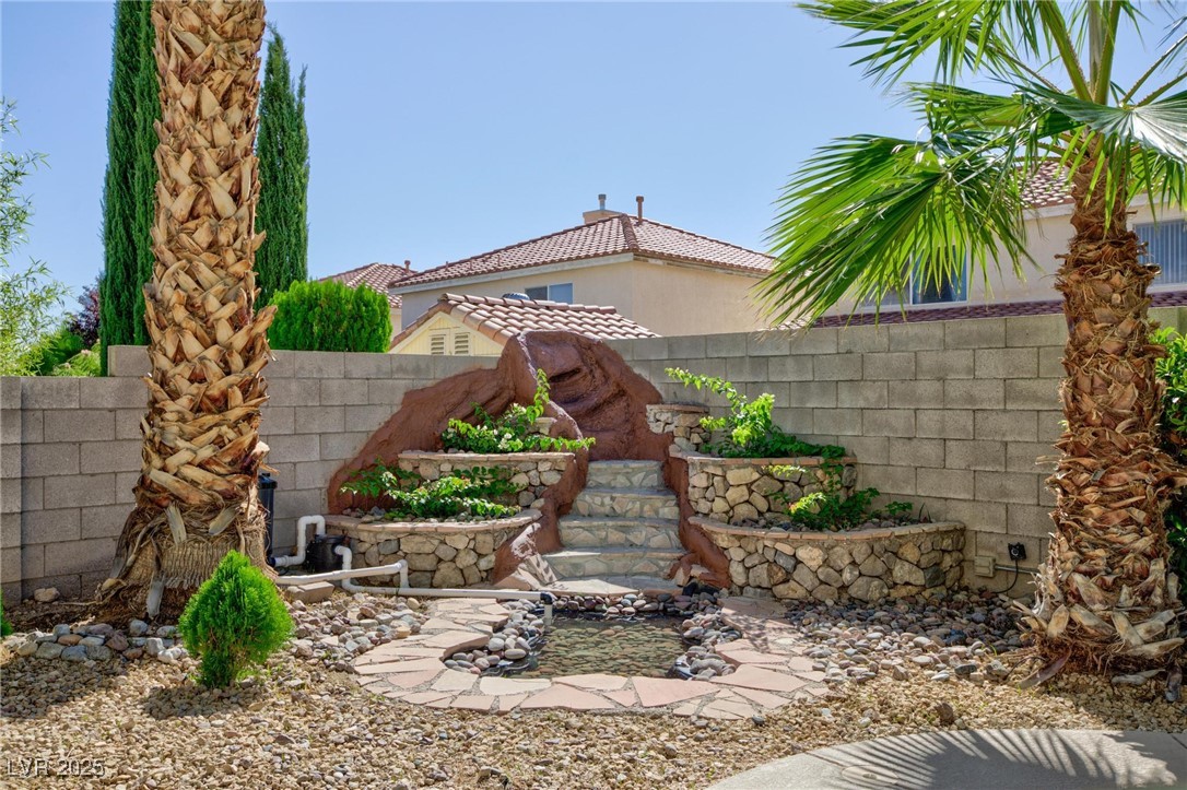 9591 Antelope Bend Court Las Vegas, NV 89148 - Photo 49 of 56 View of yard with a garden pond and a patio
