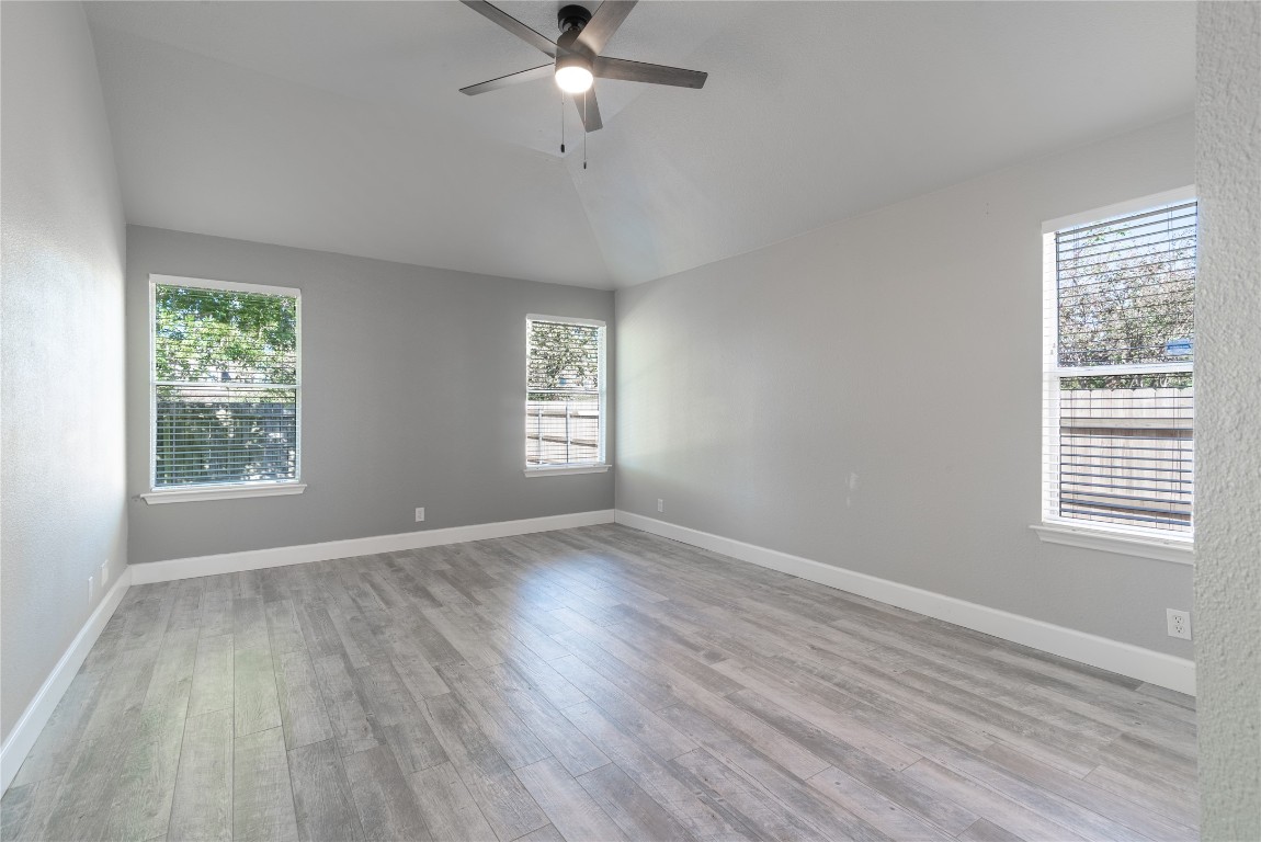 216 Brickyard Lane Jarrell, TX 76537 - Photo 15 of 33 a view of an empty room with wooden floor and a window