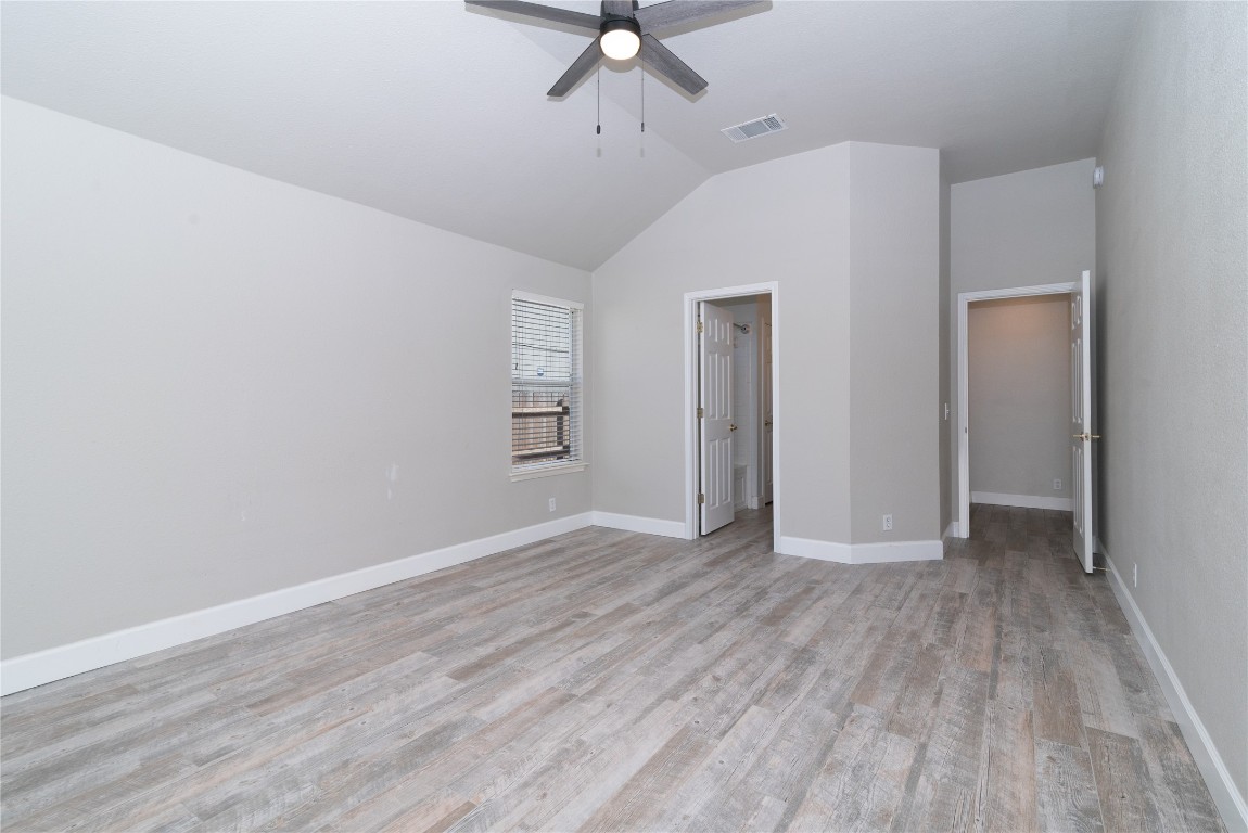 216 Brickyard Lane Jarrell, TX 76537 - Photo 16 of 33 wooden floor in an empty room with a window