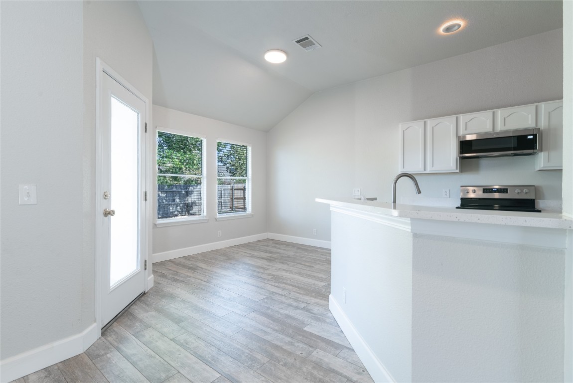 216 Brickyard Lane Jarrell, TX 76537 - Photo 3 of 33 a kitchen with a sink a window and cabinets