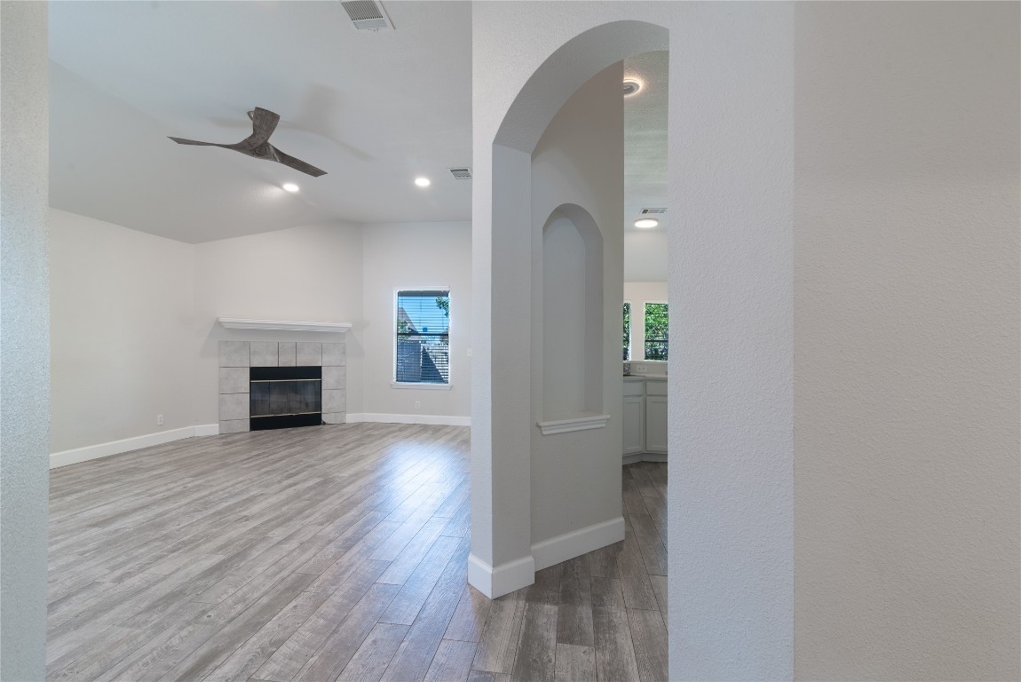 216 Brickyard Lane Jarrell, TX 76537 - Photo 5 of 33 wooden floor in an empty room with a fireplace
