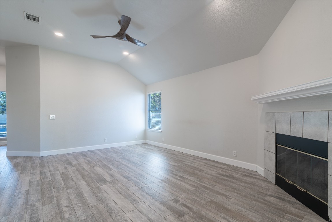 216 Brickyard Lane Jarrell, TX 76537 - Photo 8 of 33 an empty room with wooden floor and windows