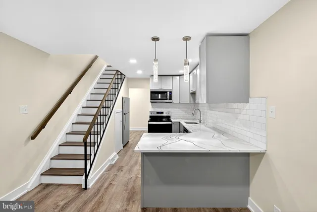 a kitchen with sink microwave and cabinets