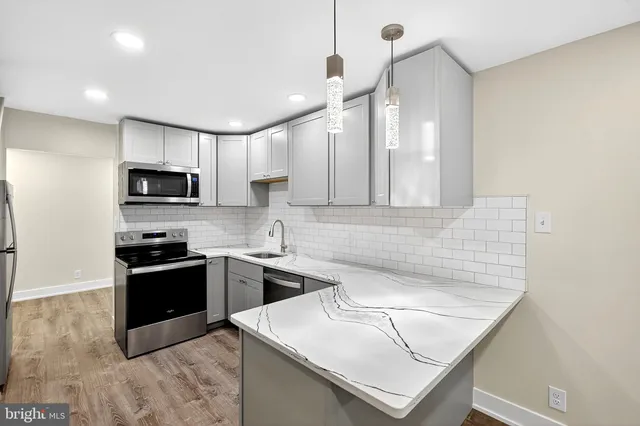 a kitchen that has a sink and a stove top oven