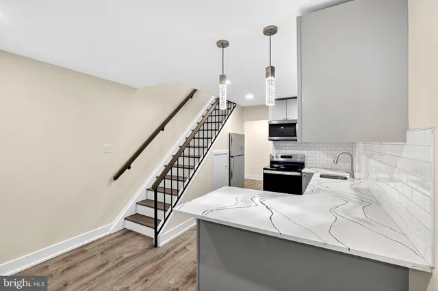 a view of a kitchen with furniture and staircase