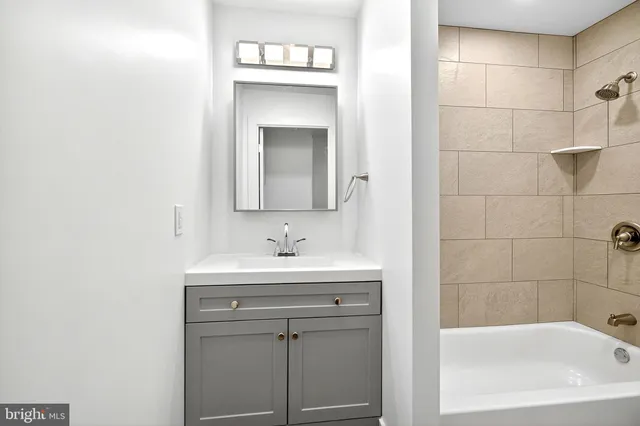 a bathroom with a sink a toilet and mirror