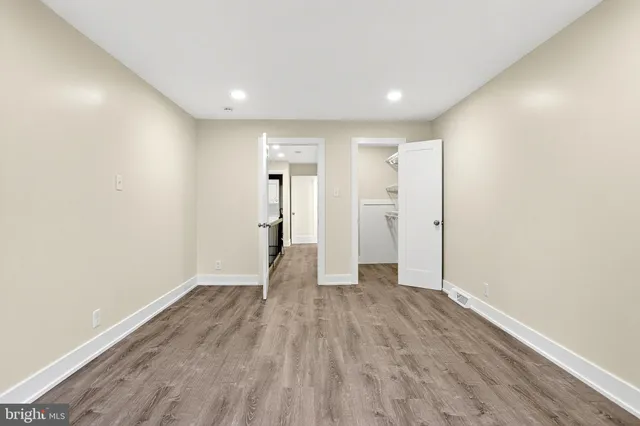 a view of empty room with wooden floor