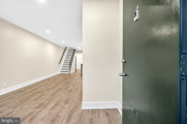 a view of a hallway with wooden floor