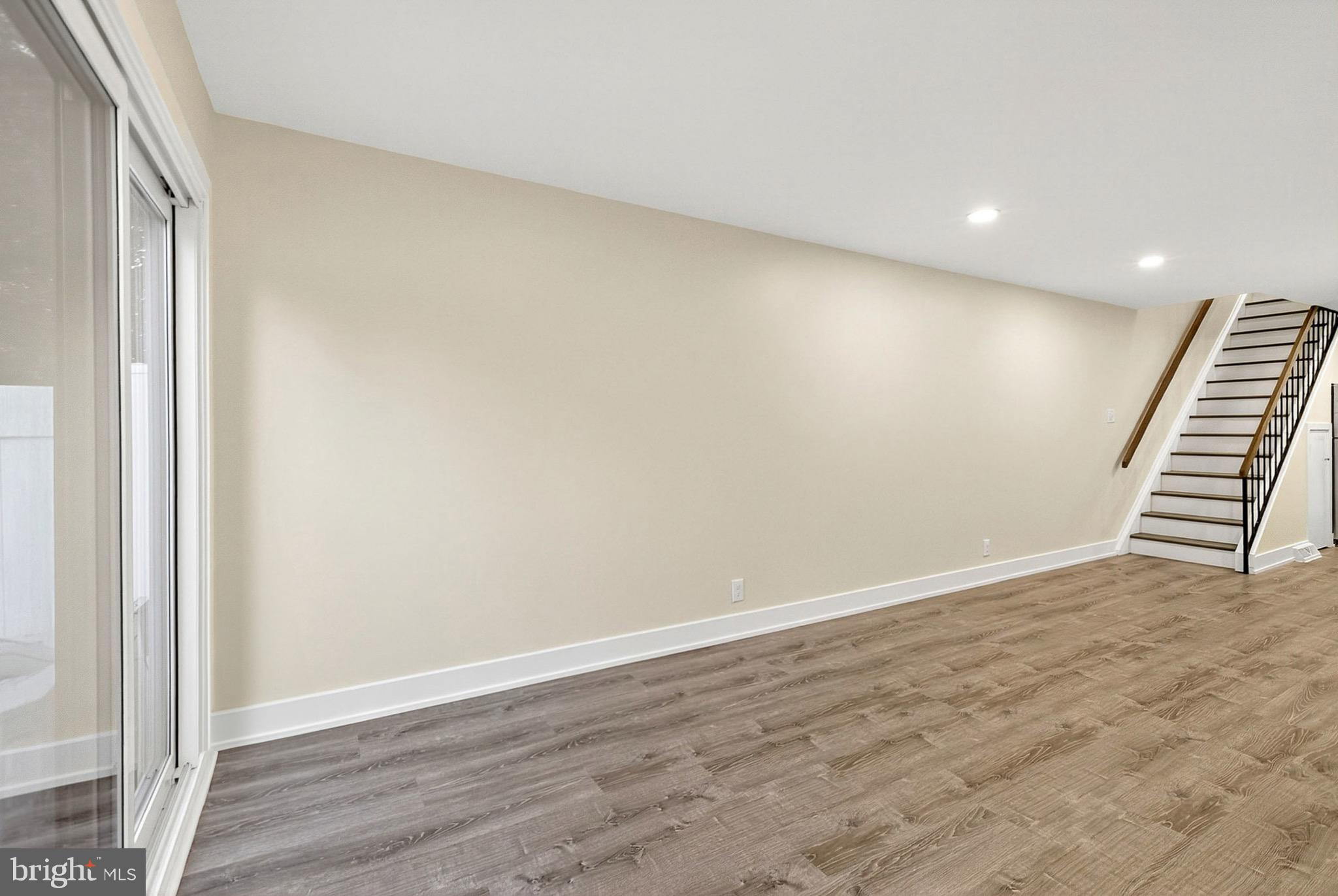 567 Summit House West Chester, PA 19382 - Photo 8 of 31 a view of an empty room with wooden floor and stairs