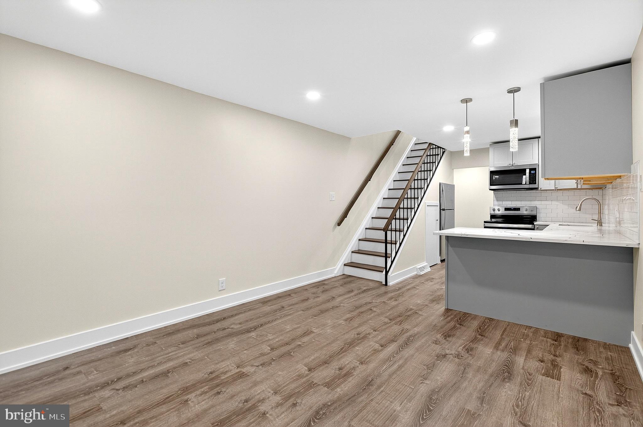 567 Summit House West Chester, PA 19382 - Photo 10 of 31 a view of kitchen with wooden floor electronic appliances and stairs