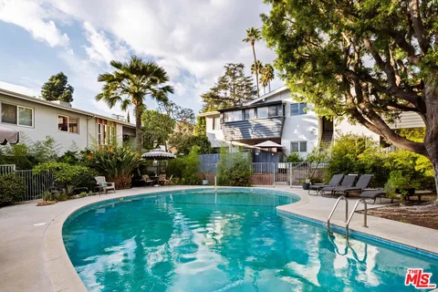 a swimming pool with outdoor seating and yard