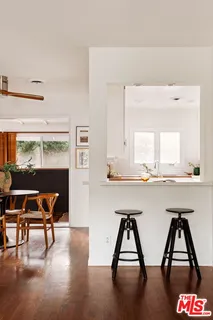 a room with a table chairs and a wooden floor