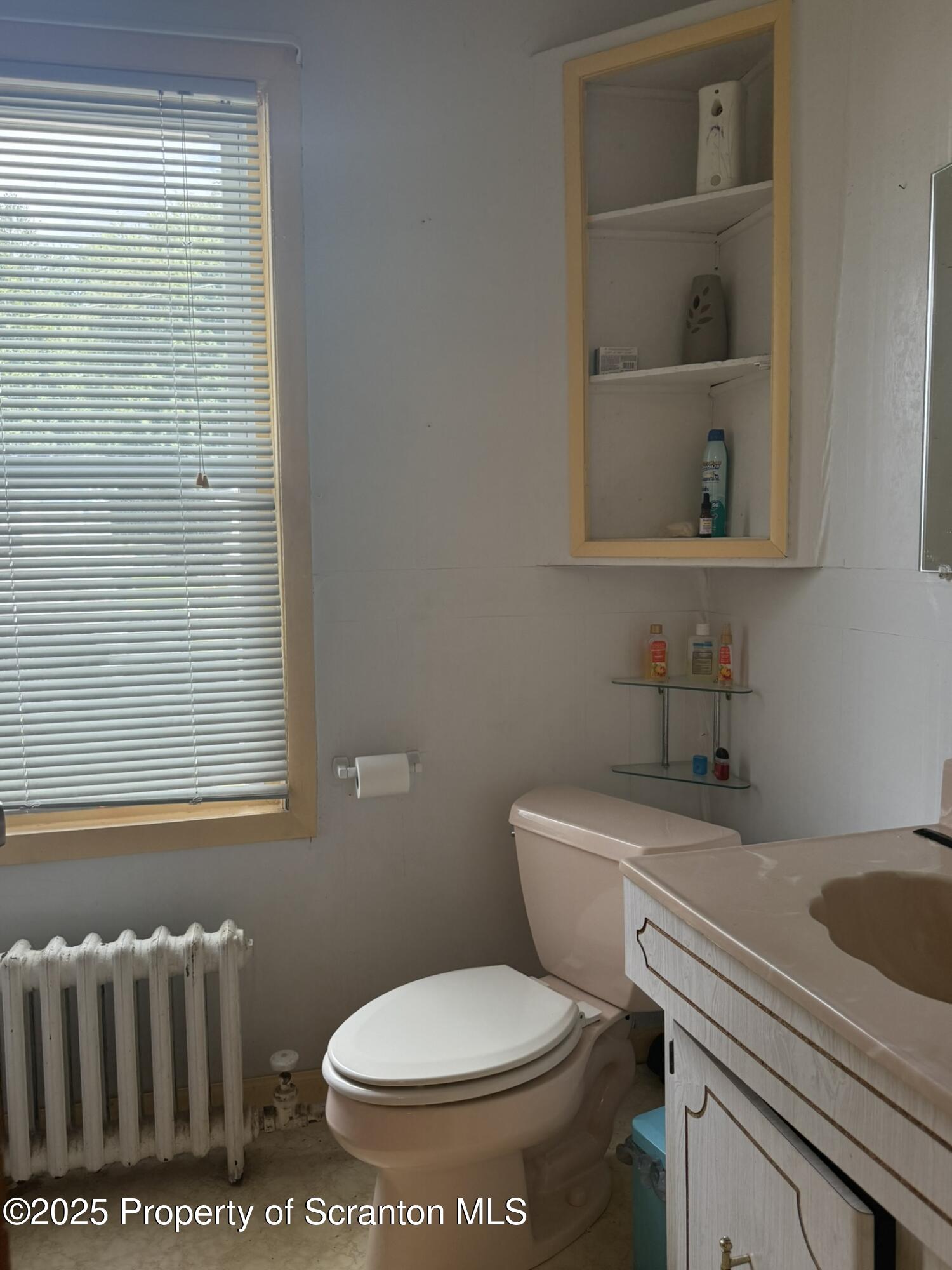 1919 Price Street Scranton, PA 18504 - Photo 31 of 44 a white toilet sitting next to a bathroom sink