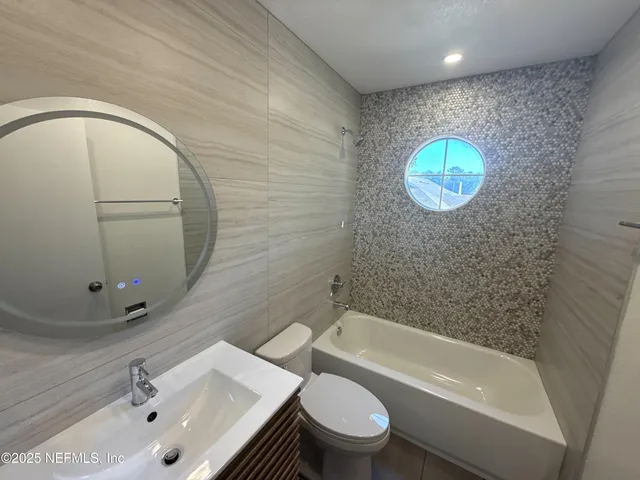 a bathroom with a sink a toilet and bathtub