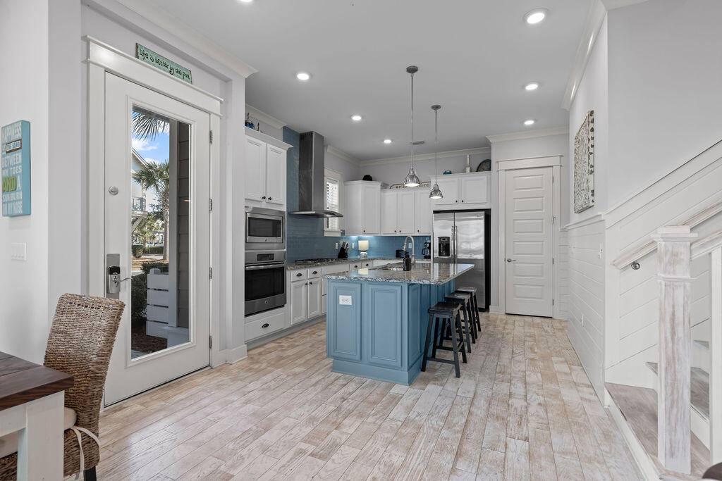 10 York Ln Inlet Beach, Unit B Inlet Beach, FL 32461 - Photo 11 of 46 a kitchen with kitchen island wooden cabinets and refrigerator