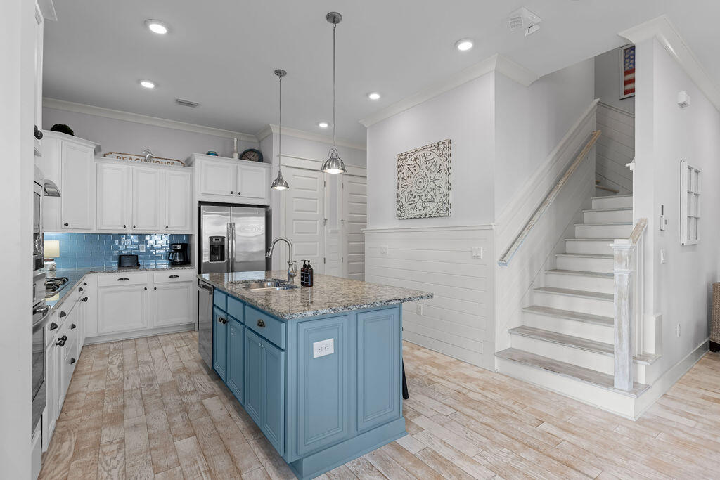 10 York Ln Inlet Beach, Unit B Inlet Beach, FL 32461 - Photo 12 of 46 a kitchen with granite countertop a sink a counter top space stainless steel appliances and cabinets