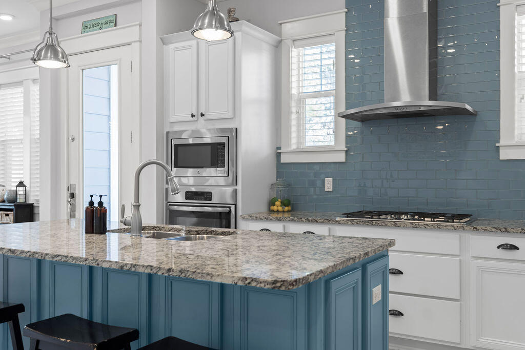 10 York Ln Inlet Beach, Unit B Inlet Beach, FL 32461 - Photo 13 of 46 a kitchen with stainless steel appliances granite countertop a sink a stove and a microwave