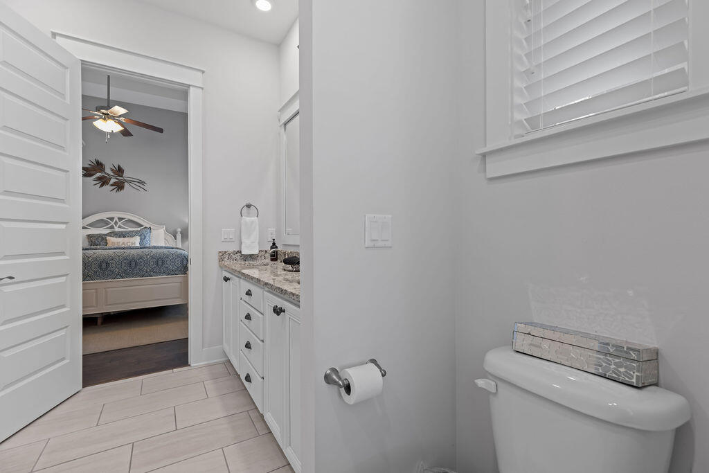 10 York Ln Inlet Beach, Unit B Inlet Beach, FL 32461 - Photo 26 of 46 a bathroom with a toilet a sink and mirror