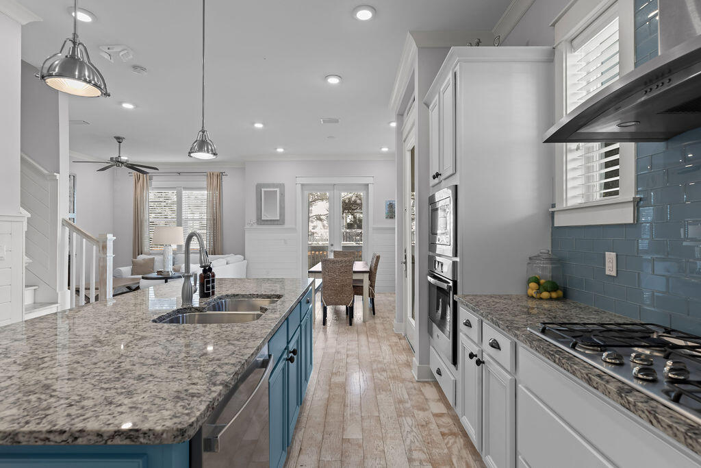 10 York Ln Inlet Beach, Unit B Inlet Beach, FL 32461 - Photo 6 of 46 a kitchen with granite countertop a stove a sink a refrigerator and a counter space