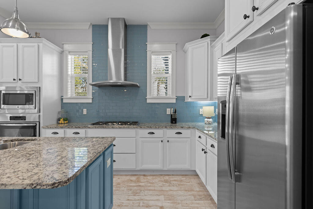 10 York Ln Inlet Beach, Unit B Inlet Beach, FL 32461 - Photo 7 of 46 a kitchen with stainless steel appliances granite countertop a sink stove and refrigerator