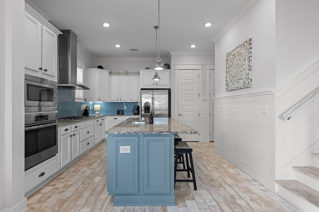 10 York Ln Inlet Beach, Unit B Inlet Beach, FL 32461 - Photo 10 of 46 a kitchen with stainless steel appliances granite countertop a refrigerator oven a sink dishwasher and a stove with wooden floor