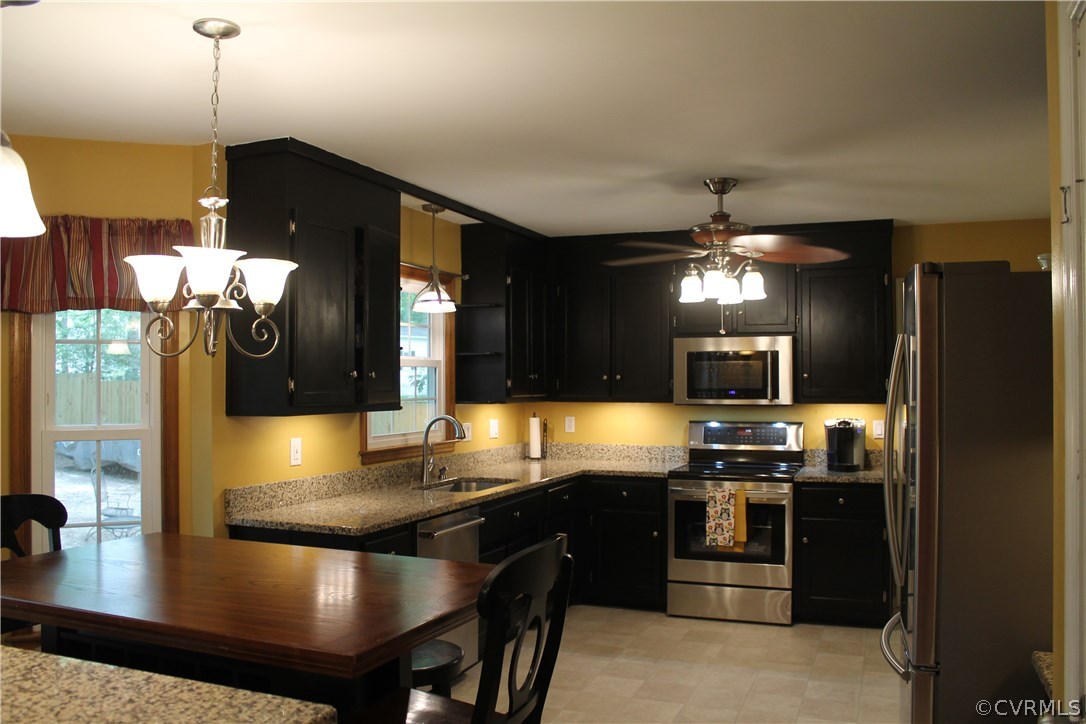 10718 Ridgerun Road Chesterfield, VA 23832 - Photo 29 of 50 a kitchen with stainless steel appliances granite countertop a sink a stove and a refrigerator