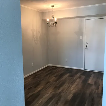 a view of a room with wooden floor and brick walls