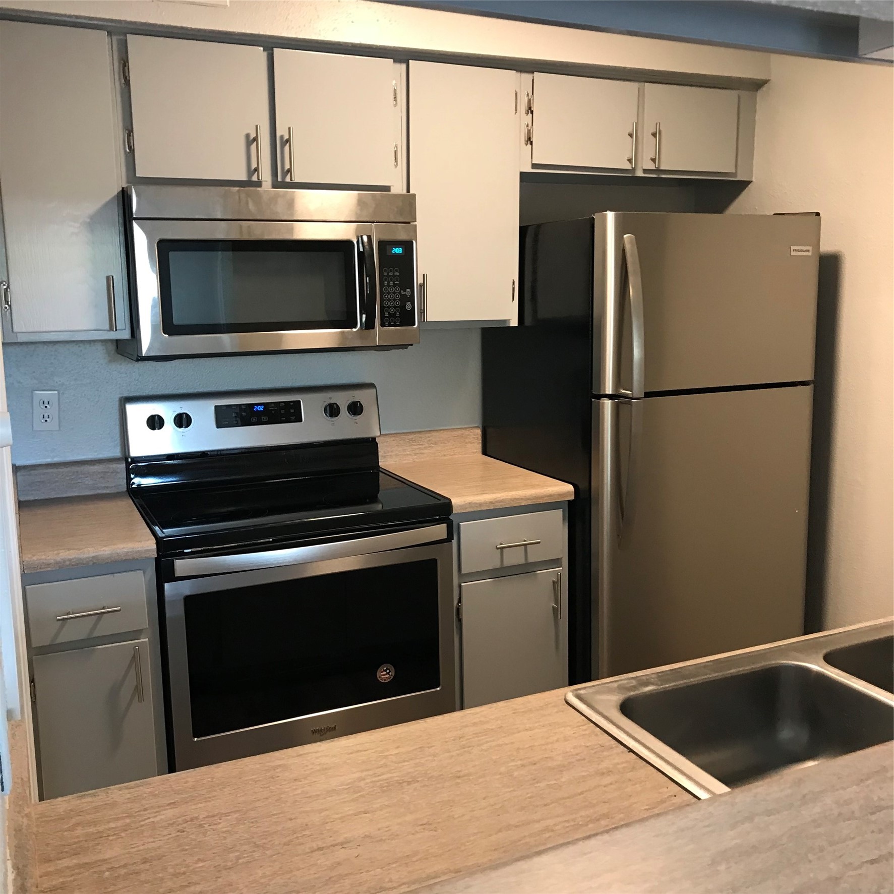 4631 Wild Indigo Street, Unit 560 Houston, TX 77027 - Photo 4 of 12 a kitchen with a refrigerator stove and microwave