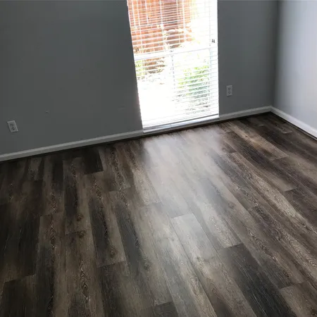 a view of wooden floor and windows in a room